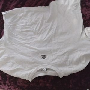 White Adidas crop top.